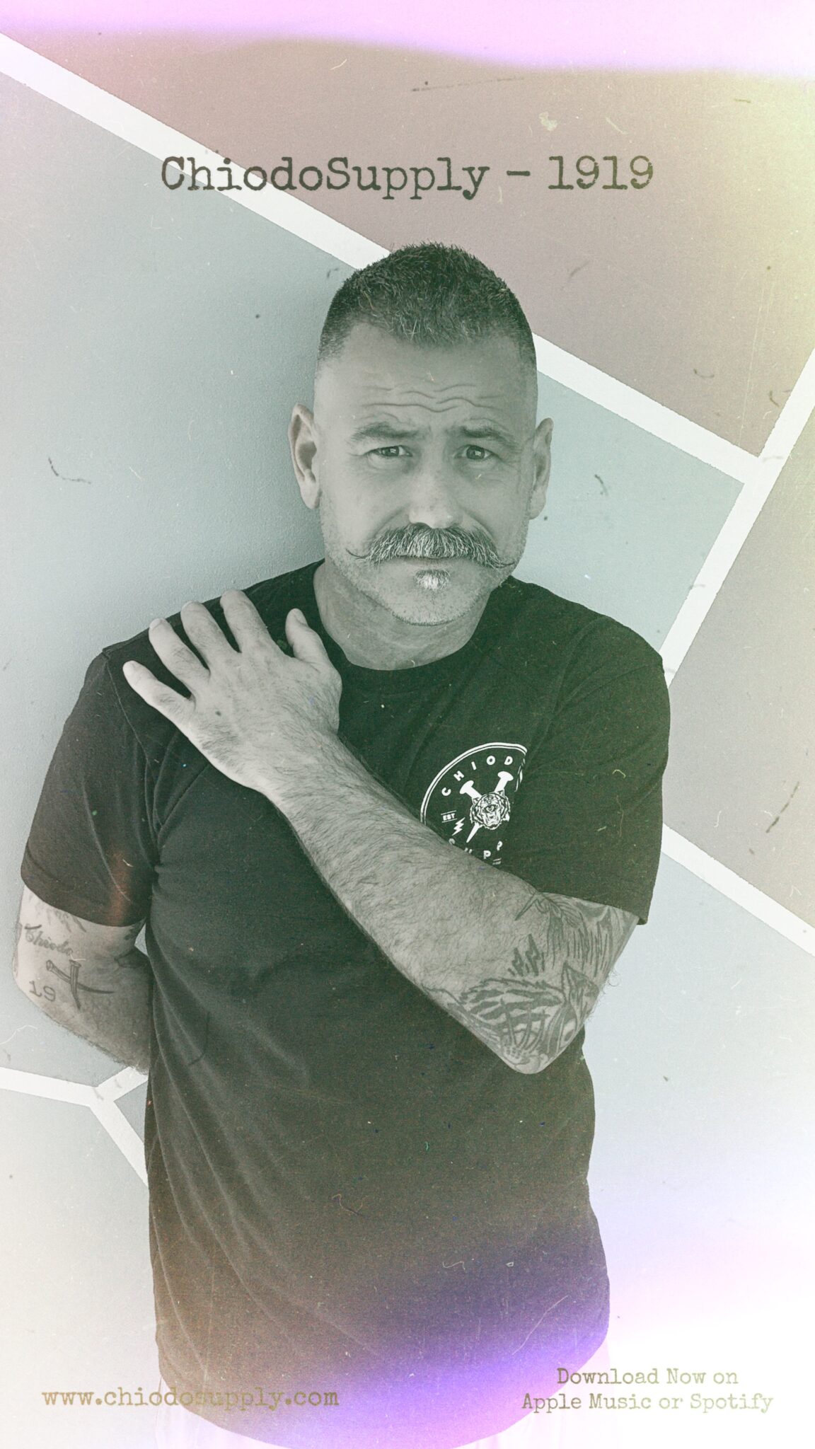 Artist ChiodoSupply standing against a wall with hand on shoulder.